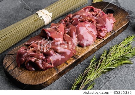 Raw liver chicken offal meat, on gray stone table background Raw liver chicken offal meat, on gray stone table background 85235385