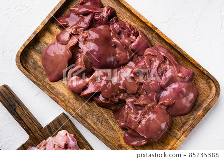 Raw chicken liver, on white stone table background, top view flat lay Raw chicken liver, on white stone table background, top view flat lay 85235388