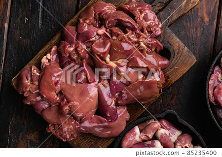 Raw liver chicken offal meat, on old dark wooden table background, top view flat lay 85235400