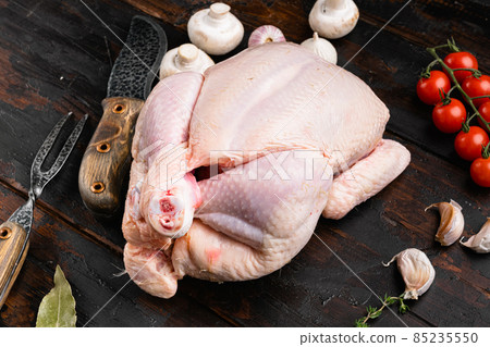 Raw organic uncooked whole chicken, on old dark wooden table background 85235550