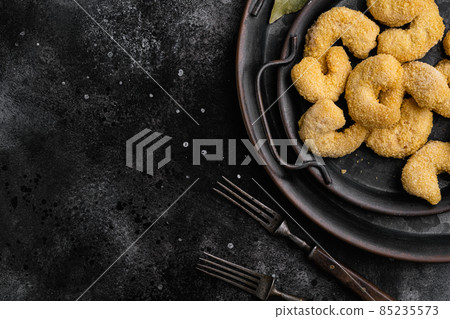 Uncooked shrimps in cheese breading, on black dark stone table background, top view flat lay, with copy space for text Uncooked shrimps in cheese breading, on black dark stone table background, top view flat lay, with copy space for text 85235573