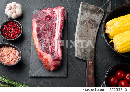 Sirloin beef meat marbled steak, Club steak cut , on stone board , with old butcher cleaver knife, on black stone background Sirloin beef meat marbled steak, Club steak cut , on stone board , with old butcher cleaver knife, on black stone background 85235740