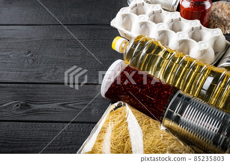 Donate food delivery concept for senior elderly in covid quarantine by volunteer with copy space, on black wooden table 85235803