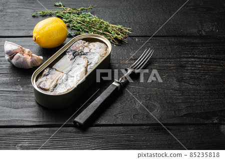 Canned sardine in oil, on black wooden table background, with copy space for text Canned sardine in oil, on black wooden table background, with copy space for text 85235818