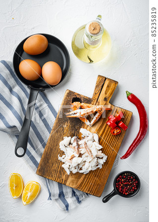 Spanish or Thai omelette ingredient, fresh red chilli, brown and white crabmeat, lemon, Cheddar cheese, eggs, on white background, top view flat lay Spanish or Thai omelette ingredient, fresh red chilli, brown and white crabmeat, lemon, Cheddar cheese, eggs, on white background, top view flat lay 85235819