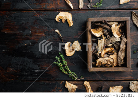 Boletus wild dried mushrooms, on old dark wooden table background, top view flat lay , with space for text copyspace Boletus wild dried mushrooms, on old dark wooden table background, top view flat lay , with space for text copyspace 85235833