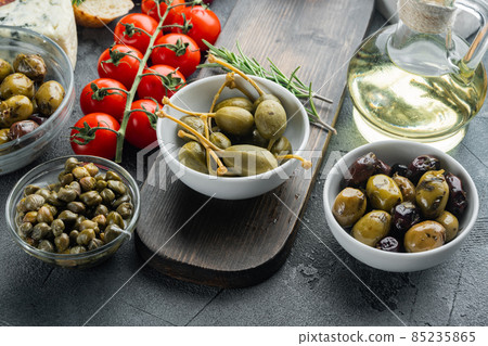Mediterranean olives and capers, on gray background Mediterranean olives and capers, on gray background 85235865
