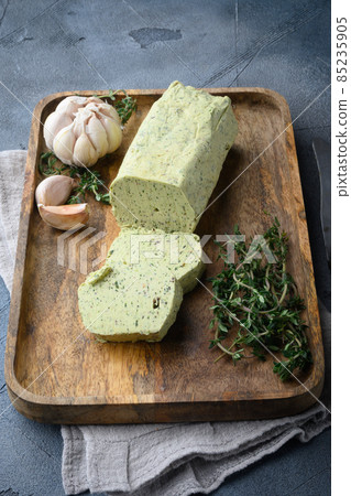 Fresh green herb butter, on gray stone background 85235905