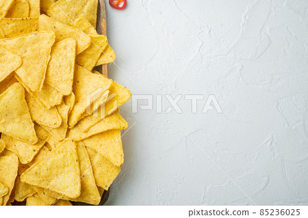 Mexican crispy snack, nachos chips and cheese guacamole avocado sauce, on white background, top view or flat lay with copy space for text 85236025