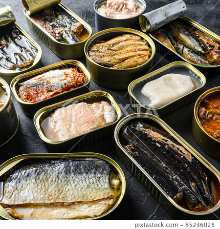 Tin can of Saury, mackerel, sprats, sardines, pilchard, squid, tuna Open and closed over black slate background side view square Tin can of Saury, mackerel, sprats, sardines, pilchard, squid, tuna Open and closed over black slate background side view square 85236028