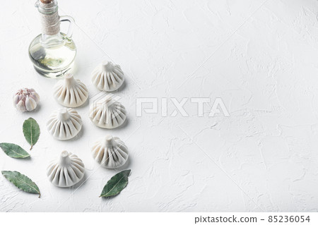 Uncooked Baozi chinese dumplings. Azian dumplings, on white stone surface, with copy space for text Uncooked Baozi chinese dumplings. Azian dumplings, on white stone surface, with copy space for text 85236054