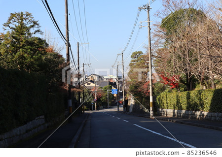 Scenery of the cityscape with a blue sky and a two-lane road Scenery of the cityscape with a blue sky and a two-lane road 85236546