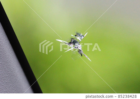 Scratches (cracks) created by stepping stones hitting the windshield of a car Scratches (cracks) created by stepping stones hitting the windshield of a car 85238428