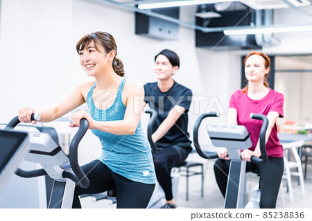 People training on a bicycle machine 85238836