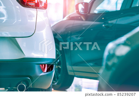 Selective focus white car parked in luxury showroom. Car dealership office. New car parked in modern showroom. Car for sale and rent business concept. Automobile leasing and insurance background. Selective focus white car parked in luxury showroom. Car dealership office. New car parked in modern showroom. Car for sale and rent business concept. Automobile leasing and insurance background. 85239207