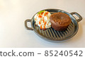 Chocolate cake with cream in the small pan on the white table 85240542