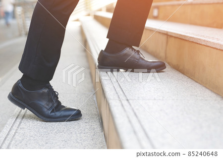 Close up legs shoes of young business man One person walking stepping going up the stairs in modern city, go up, success, grow up. with filter Tones retro vintage warm effect. stairway Close up legs shoes of young business man One person walking stepping going up the stairs in modern city, go up, success, grow up. with filter Tones retro vintage warm effect. stairway 85240648