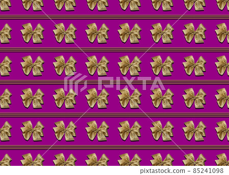 Gold bows for decorating gifts on a purple background. Beautifully tied bow, stripes between the bows. Photo of a gift package with a seamless pattern. 85241098