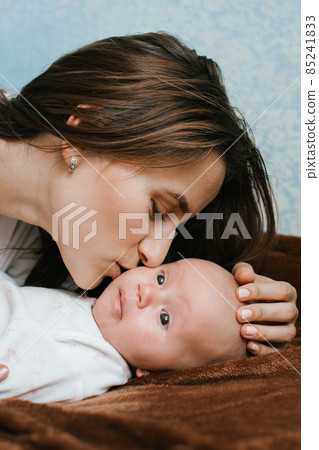 Mental Health in Postpartum Time. Maternal Mental Health. Pregnancy And Postpartum Disorders, postpartum baby blues, depression. Portrait of mother and newborn baby Mental Health in Postpartum Time. Maternal Mental Health. Pregnancy And Postpartum Disorders, postpartum baby blues, depression. Portrait of mother and newborn baby 85241833