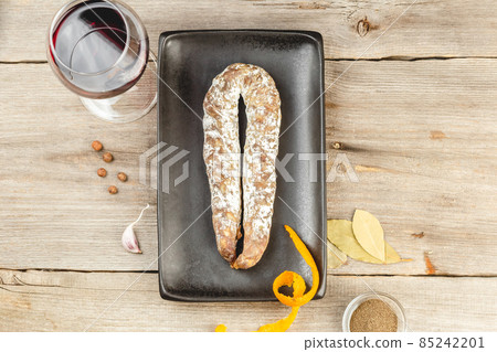 Traditional Salami Sausage on black dish with wine 85242201