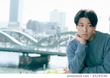 A young man looking out in a boring way A young man looking out in a boring way 85243540