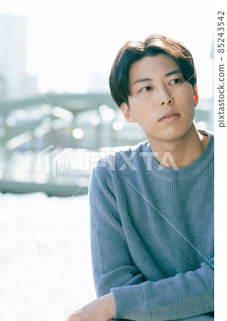 A young man looking out in a boring way 85243542