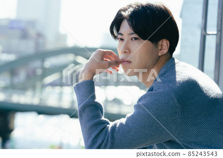 A young man looking out in a boring way A young man looking out in a boring way 85243543