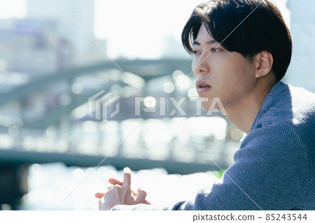 A young man looking out in a boring way A young man looking out in a boring way 85243544