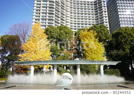 國京外苑和田倉噴泉公園:在晴朗的天空和彩色的銀杏葉中閃耀的噴泉。噴泉中可以看到彩虹。 國京外苑和田倉噴泉公園:在晴朗的天空和彩色的銀杏葉中閃耀的噴泉。噴泉中可以看到彩虹。 85244352