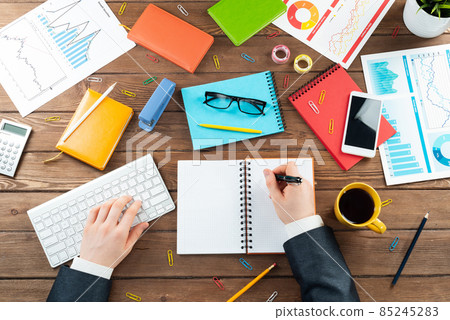 Businessman hands working at vintage wooden desk Businessman hands working at vintage wooden desk 85245283
