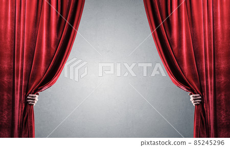 Concrete wall behind drapery curtain and hand opening it Concrete wall behind drapery curtain and hand opening it 85245296