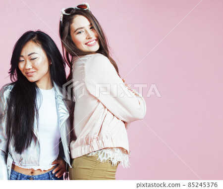 different nation girls with diversuty in skin, hair. Asian, scandinavian, african american cheerful emotional posing on pink background, woman day celebration, lifestyle people concept different nation girls with diversuty in skin, hair. Asian, scandinavian, african american cheerful emotional posing on pink background, woman day celebration, lifestyle people concept 85245376