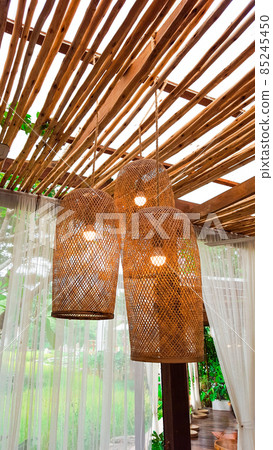 Brown dried weaved bamboo lamps hanging from the cailing Brown dried weaved bamboo lamps hanging from the cailing 85245450
