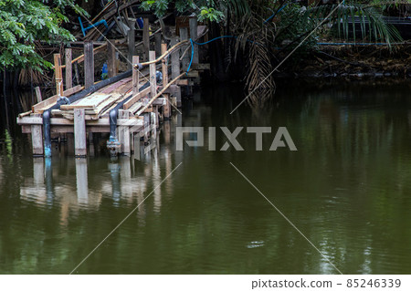 A wooden bridge over a small river. A wooden bridge over a small river. 85246339