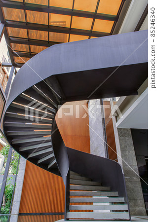 Side view of a spiral staircase pattern. Spiral stairs circle in courtyard architecture. Outdoor ladder decoration interior. Side view of a spiral staircase pattern. Spiral stairs circle in courtyard architecture. Outdoor ladder decoration interior. 85246340