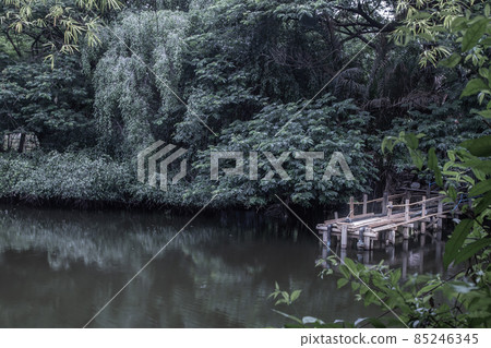 A wooden bridge over a small river. A wooden bridge over a small river. 85246345