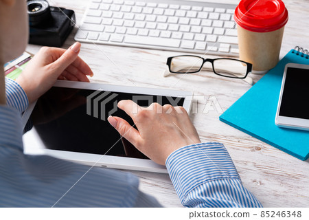 Business consultant sitting at desk with coffee 85246348