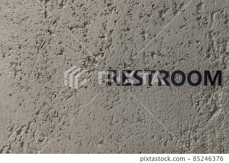 Restroom : signage in black letters. Characters on the bare cement wall background. 85246376