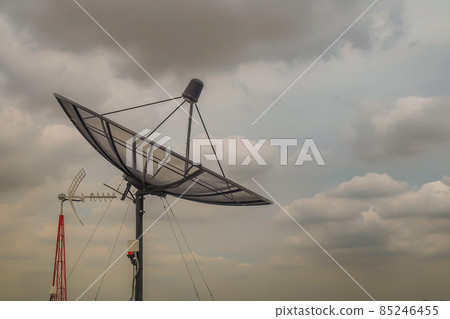 Black Satellite Dish Antenna Receiver Against on Blue Sky background  for Communication and Media Industry. 85246455