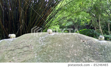 Three sheep dolls on a stone in the mountains Three sheep dolls on a stone in the mountains 85246465