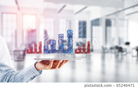 Close of businessman holding tablet pc with progressing graph icon Close of businessman holding tablet pc with progressing graph icon 85246471