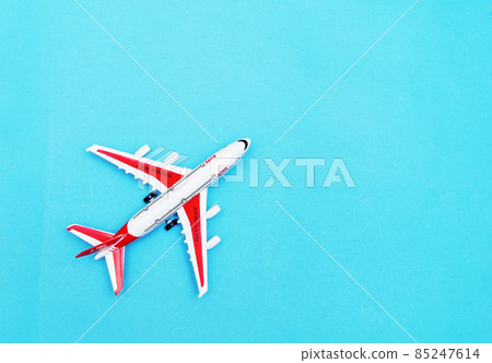 White and red Passenger Model airplane on a blue background. Free space for text. Travel concept. White and red Passenger Model airplane on a blue background. Free space for text. Travel concept. 85247614