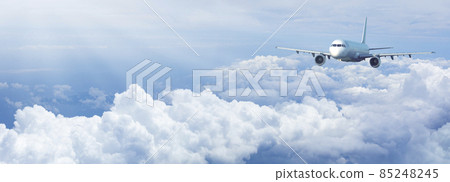 Jet plane in a blue cloudy sky. 85248245