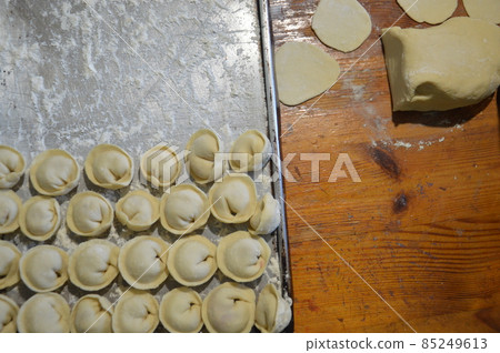 Woman sculpts dumplings at home 85249613
