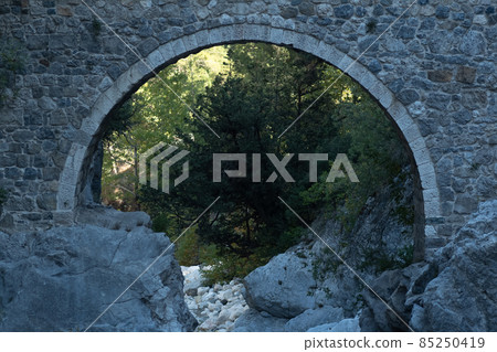 arch of ancient Roman bridge over a mountain river in the Kesme Bogazi canyon, Turkey arch of ancient Roman bridge over a mountain river in the Kesme Bogazi canyon, Turkey 85250419