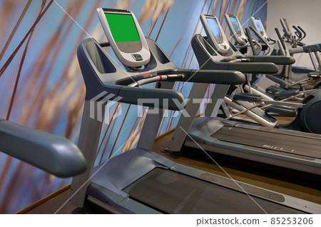 Close-up of run machines, treadmill in fitness room at gym or wellness spa resort. Fitness, sport, cardio workout, healthy and active lifestyle concept Close-up of run machines, treadmill in fitness room at gym or wellness spa resort. Fitness, sport, cardio workout, healthy and active lifestyle concept 85253206