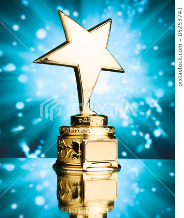 gold star trophy against blue sparks background 85253741