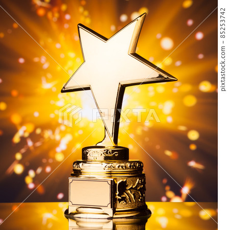 gold star trophy against shiny sparks background 85253742