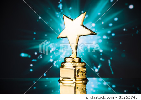 gold star trophy against blue sparks background 85253743