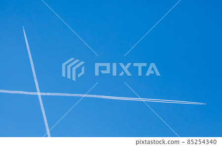 airplanes trails crossing against blue sky background 85254340